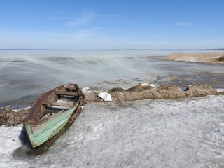 Boat in winter on the shores of lake Pleshcheyevo, Pereslavl Zalessky, Yaroslavl region, Russia on a clear day.