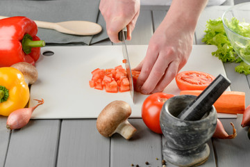 Man chopping a tomato
