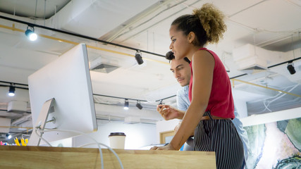 Successful team at work. Group of young business people working and communicating together in creative office