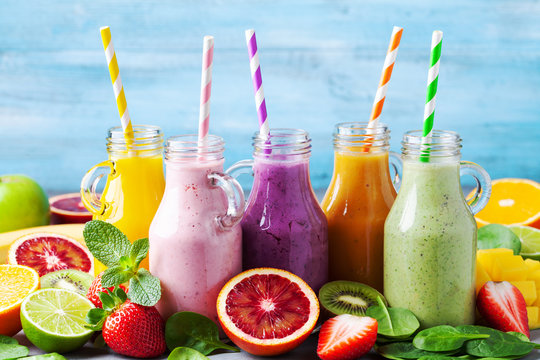 Summer colorful fruit smoothies in jars with ingredients. Healthy, detox and diet food concept.