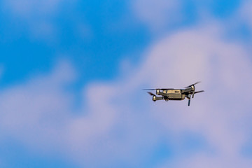 Fototapeta na wymiar Drone on a background of blue sky with clouds.