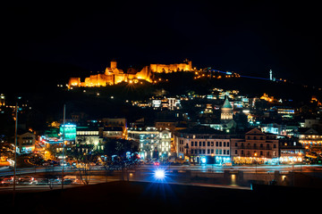 Fototapeta na wymiar Georgia, Tbilisi - 05.02.2019. - View over Narikala fortress and Tbilisi old town architecture illuminated in the night time.