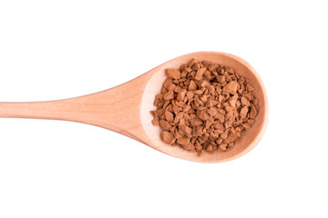 Granulated coffee in a spoon close-up. Instant coffee in a wooden spoon.