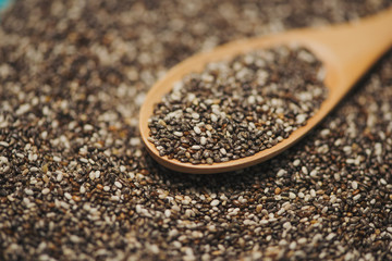 Close-up of ealthy chia seeds in a spoon. Text space.