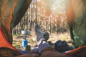 wanderlust outdoor camping - traveler feet out of the tent - obrazy, fototapety, plakaty