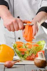 Adding carrot ribbons into salad