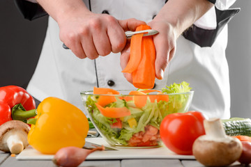 Chef peeling a carrot