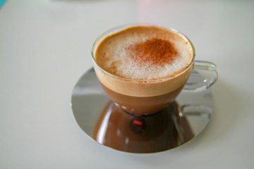 cup of coffee with whipped cream on a white background