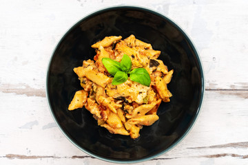 Penne gratin with vegetables, grilled zucchini and marinated tomatoes