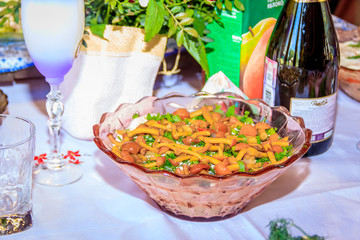 Salad with mushrooms on the holiday table. Salad