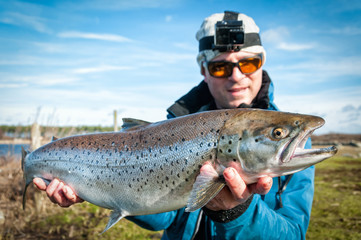 Happy angler with big sea trout