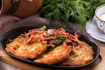 Potato pancakes with bacon and mushrooms.