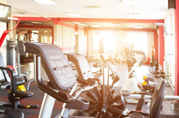 Gym interior with new sports equipment, treadmills and health, sun, background, running track, cardio
