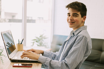 student with computer on desktop