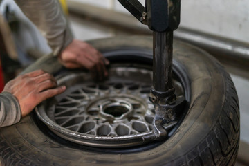 Replace tire on wheel in auto repair service