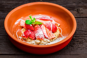 Close up strawberry dessert with cookie crumbles