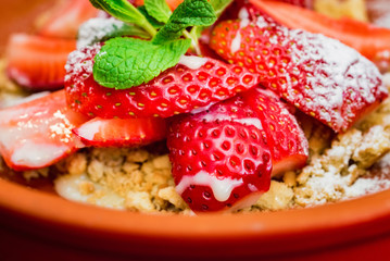 Close up strawberry dessert with cookie crumbles
