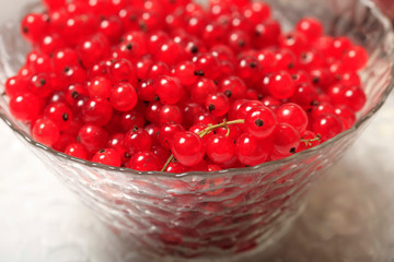 Fresh red currant berries in a glass bowl close up