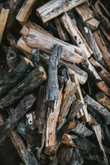 Pile of dried and burnt wood fire logs for fire camp in the Akha village of Maejantai on the hill in Chiangmai, Thailand.