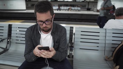 Tourist in Barcelona Underground waiting for transport.