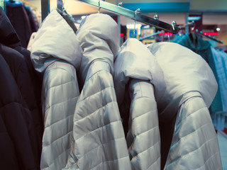 Women light jackets on showcase of market. Best gift for a woman.