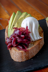 Topped Bread with different toppings salmon cream cheese, eggs avocado eggs