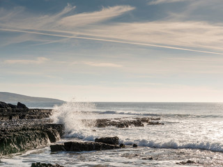 Wave crushing on rocks creating splash, West coast of Ireland. County Clare.