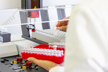 Chromatography researcher prepare small bottles for analyse