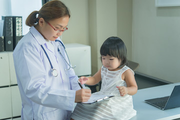 Asian doctor has a stethoscope to check his breathing and heart of a lovely girl, check the health of children,Thailand people
