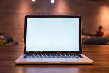 Conceptual workspace, Laptop computer with blank white screen on table, blurred background. use in Traditional Chinese Alphabet operating system.