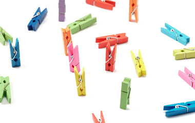 Colorful wooden clothespins on white background