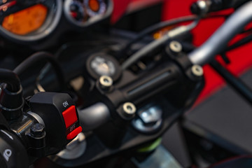 Fototapeta na wymiar Motorcycle handlebar start stop system. Close up detail of racing motorcycle handlebar. Selective focus for background. Motorsport background concept.