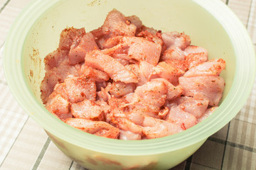 Small pieces of raw chicken in green eggplant for pickling.