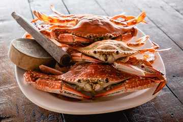 steamed flower crabs in the dish on wooden table