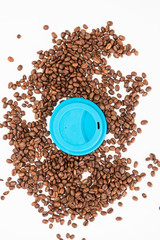 Top View of Silicone Coffee Cup Lids On Coffee Beans on White Background