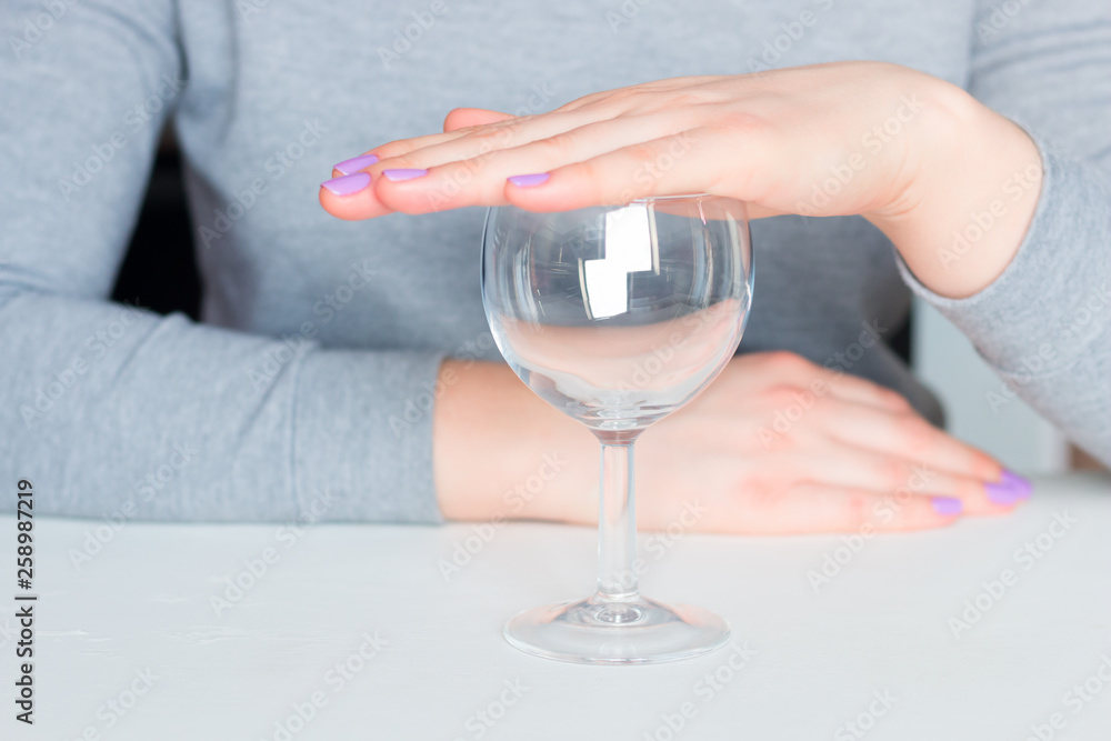 Wall mural young woman and empty glass - refusal of alcohol