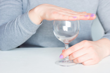 young woman covers her glass refusal alcohol