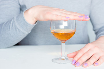 woman covers her glass with alcohol. concept stop alcoholism