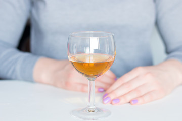 alcoholic woman and glass with alcohol closeup
