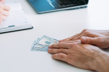 Anti corruption concept. Illegal deal payment in dollars. Man offering bribery at office. Dirty business.