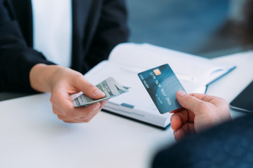 Cashless payment. Money transfer. Bank account. Online currency transaction. Man exchanging credit card for cash.
