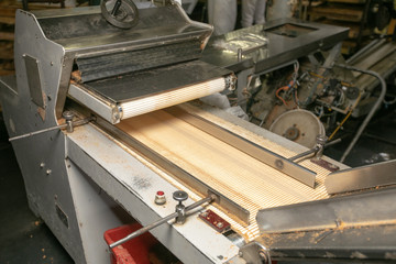 Manufacture of bread. Conveyor with dough. Capacity of the dough. Kneading dough at the bakery. Workshop of the manufacture dough.