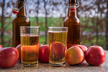 Close up Picture on two glasses or jars full of organic sparkling apple cider and two rustic...