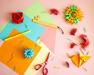 Origami. Color paper, scissors, ruler to create origami and origami products. Copy space. Background for creativity.