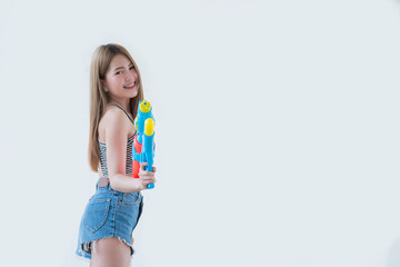 Asian sexy woman with gun water in hand on white background,Festival songkran day at thailand,The best of festival of thai,Land of  smile