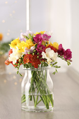 Fototapeta na wymiar Beautiful spring bright freesia flowers in vase on table