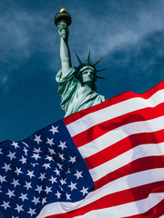 Double exposure with the American flag and the Statue of liberty. Background for independence day - 4th of July. © belyaaa