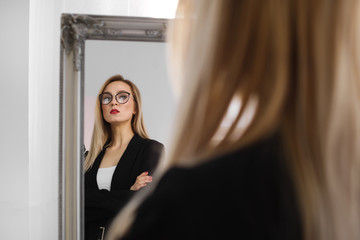 Fototapeta na wymiar business, glasses style and people concept. Close up photo of serious blonde businesswoman with red lipstick in glasses, student or secretary in eyeglasses near mirror indoor