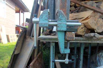 Fototapeta na wymiar iron metal heavy locksmith steel vise on the workbench in the open state closeup side view