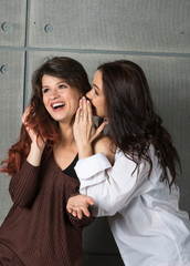 Portrait of two young beautiful girls in studio.